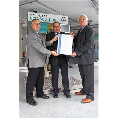 Mr. Karl Weber from TÜV SÜD presents the type examination certificate to Dr. Walter Rohregger and to Mr. Wolfgang Adldinger.